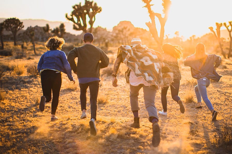 Young Adults Running in Desert